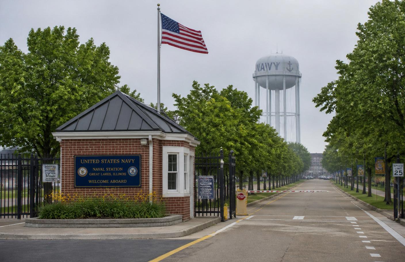 Main gate at Naval Station Great Lakes with American flag and water tower